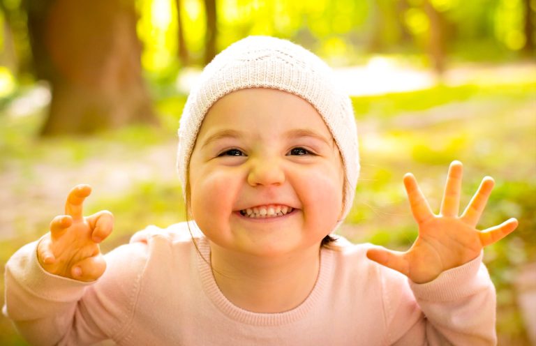 Image by Daniela Dimitrova from Pixabay. Image shows a happy little child smiling playfully for the camera.